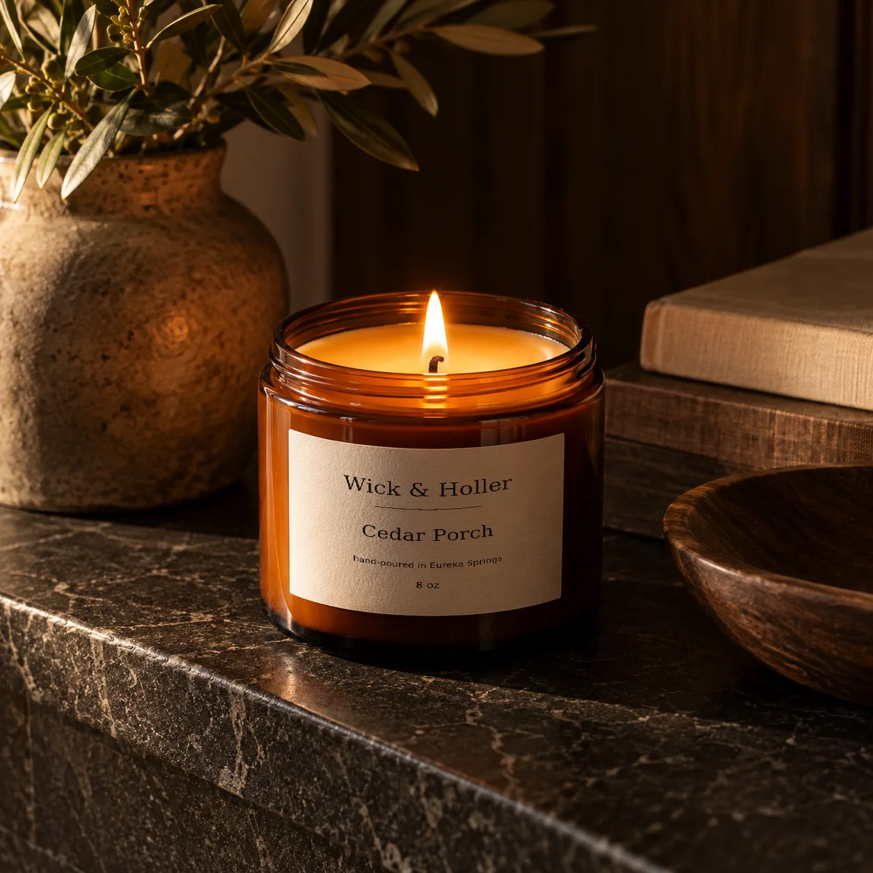 Amber candle burning on a heat-safe ledge